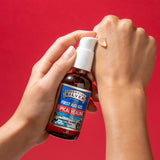 Hand applying Sovereign Silver first aid gel to another hand against a red background